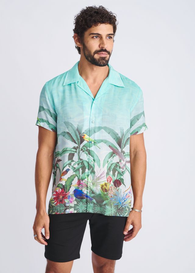 A vibrant turquoise tropical print short-sleeved modal shirt with birds and lush foliage titled tropics border print s/s modal shirt