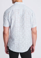 A light blue lightweight jaquard short-sleeved button-up shirt with a subtle textured pattern