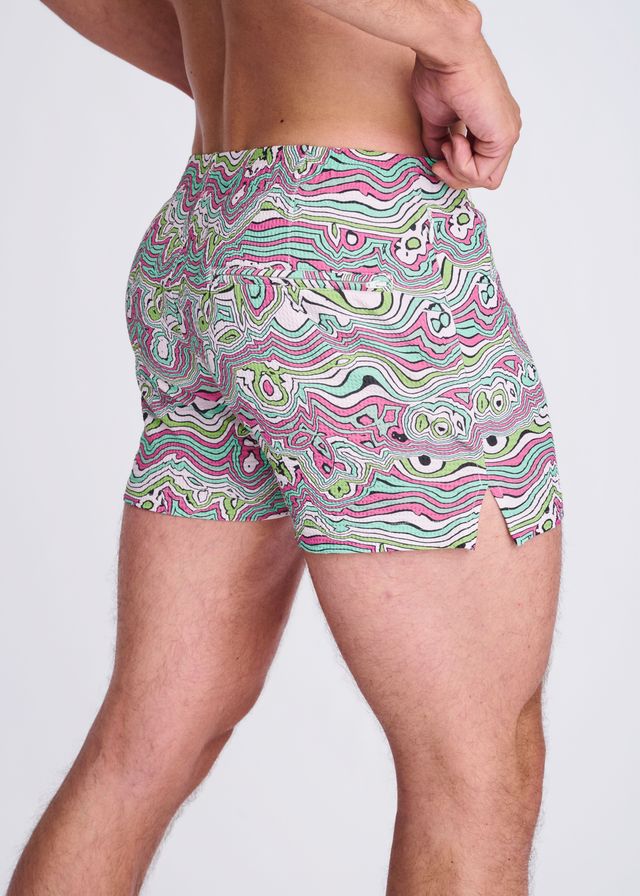 Swirls print seersucker swim shorts with mesh lining in vibrant pink green and white psychedelic wavy abstract design