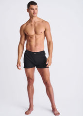 Black seersucker swim shorts with mesh lining featuring a sleek design and small button at the waistband