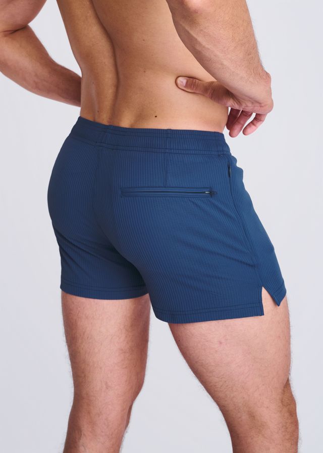 Navy blue riviera seersucker swim shorts with mesh lining side zip pocket and hem cutout in textured fabric