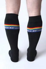 Black pride knee high socks with vibrant rainbow stripe and white military text below the stripe
