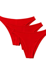 Three vibrant red thong underwear pieces made of soft fabric neatly arranged in a diagonal stack pride metro rio bikini pack