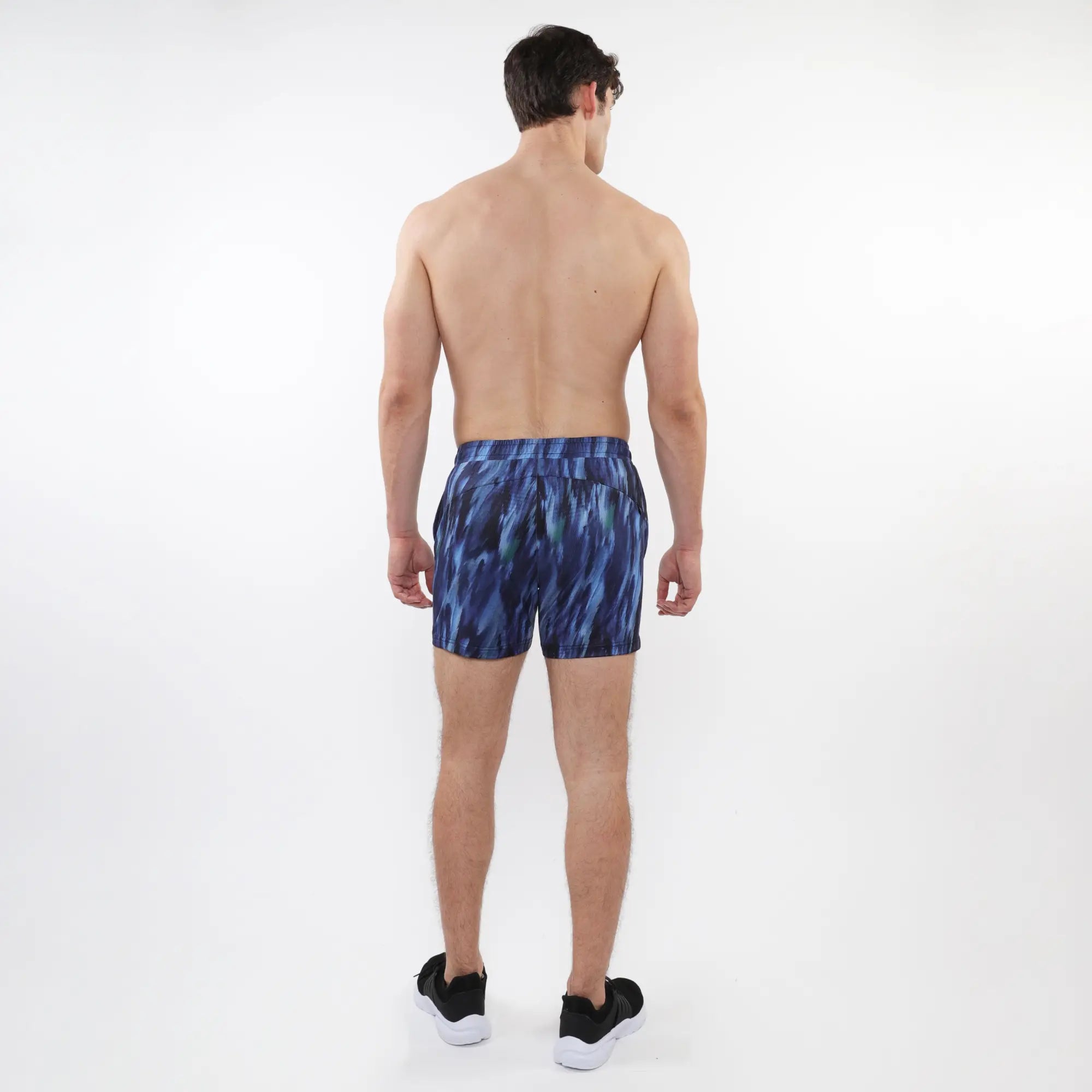 Printed mesh stretch performance shorts in blue with an abstract pattern and fitted waistband for athletic use