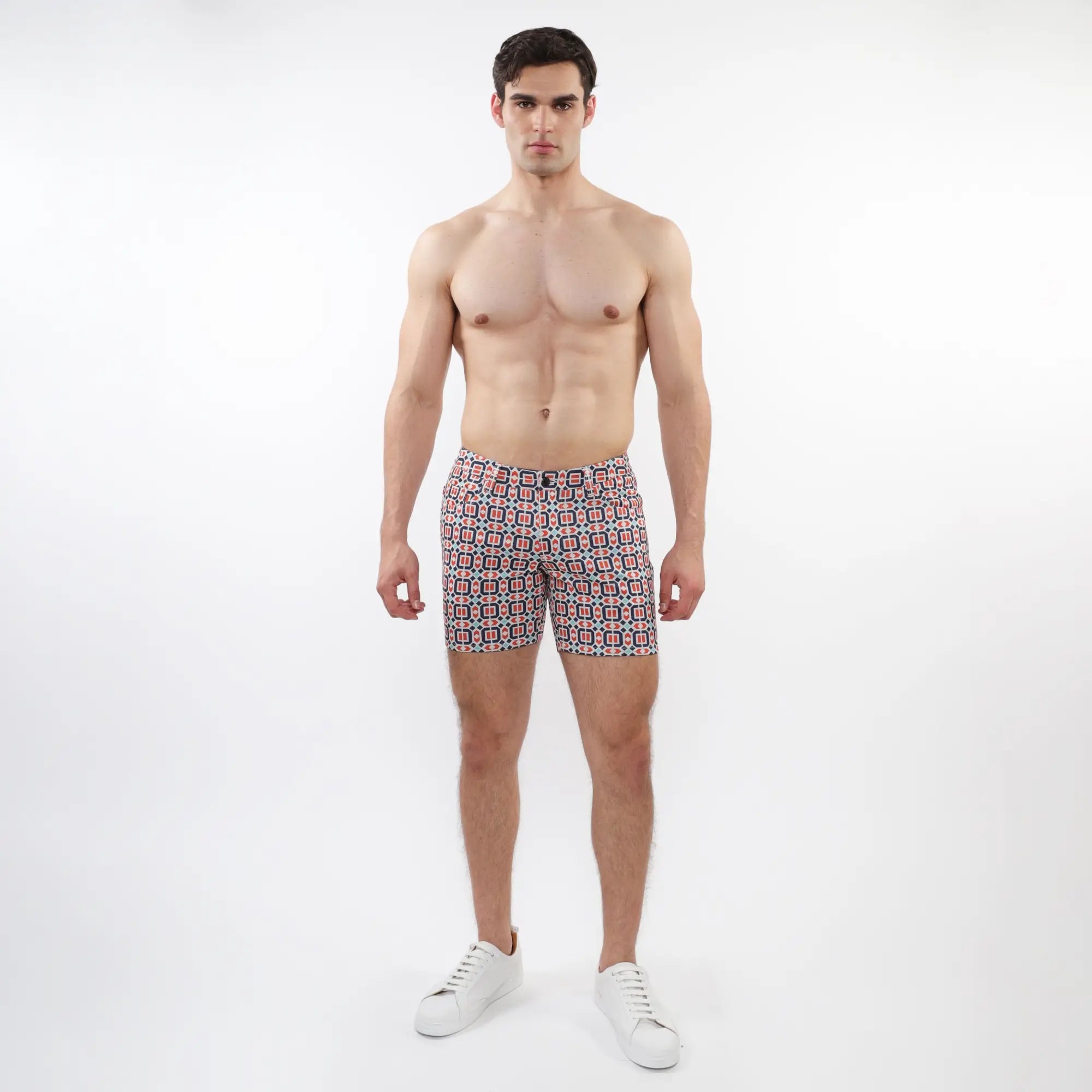 Men’s printed stretch knit swim trunks with a red blue and white geometric pattern perfect for beachwear