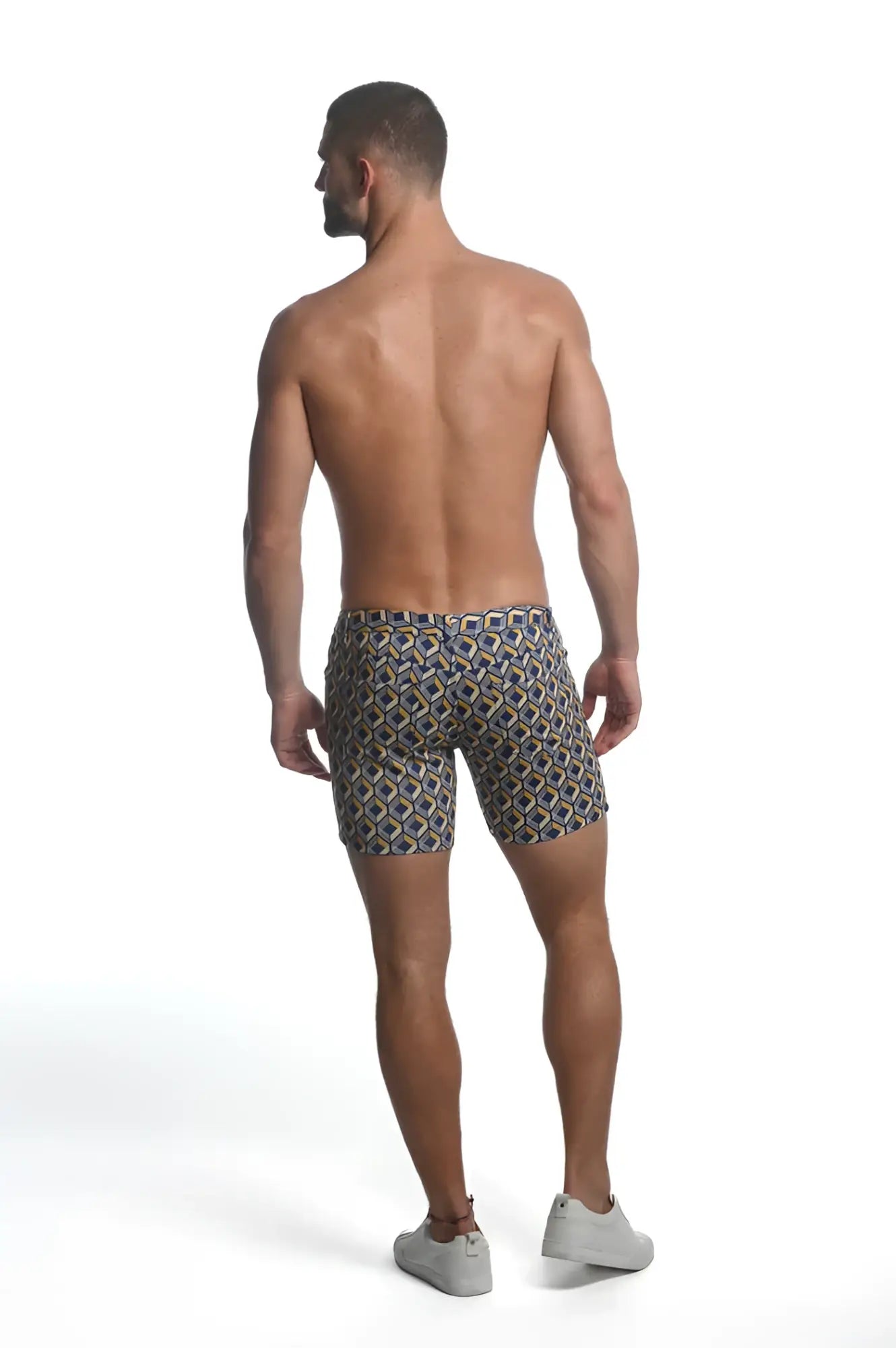 Printed stretch knit short men’s swim trunks in a geometric navy beige and gold pattern with stretch fabric