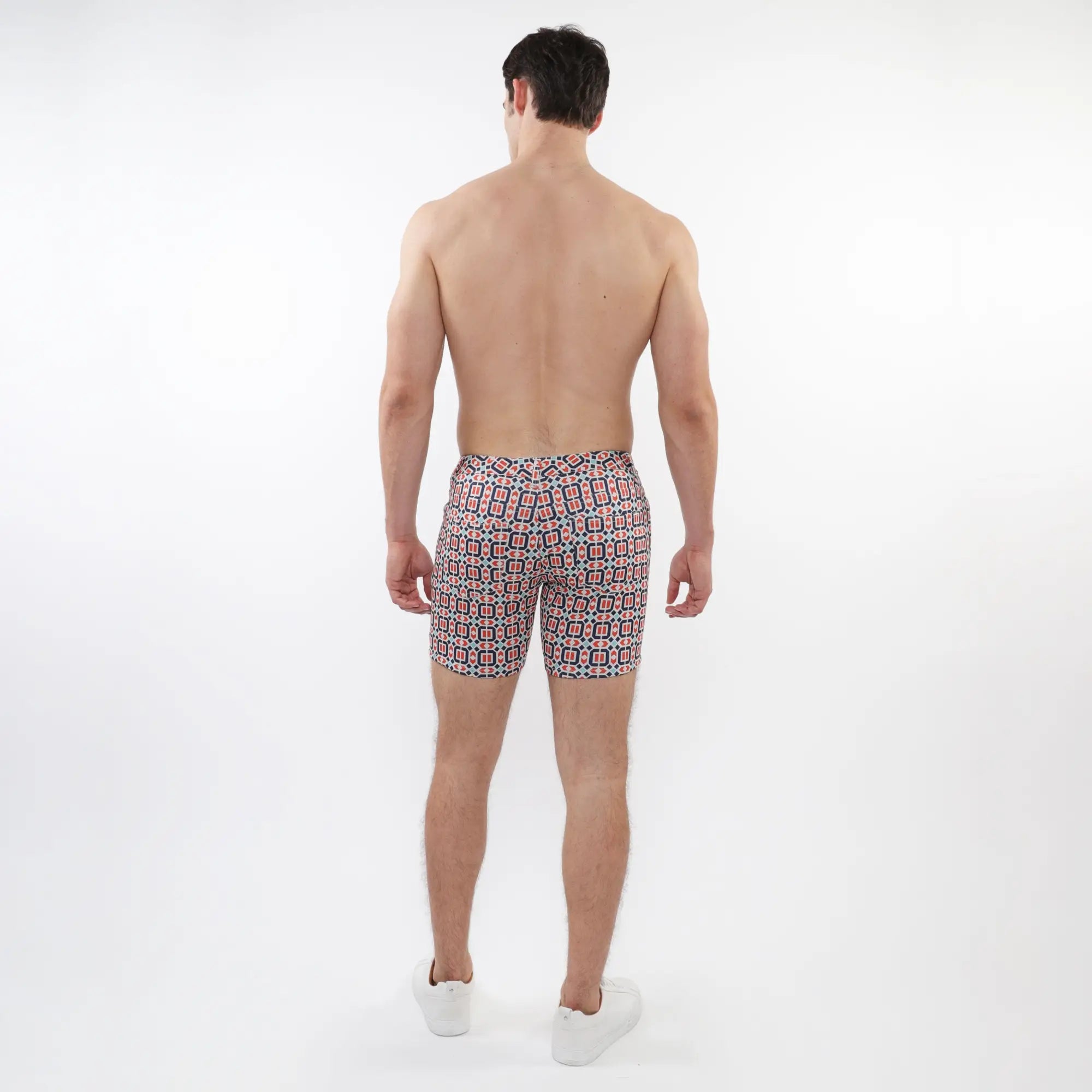 Men’s printed stretch knit short swim trunks in vibrant red black and white geometric pattern