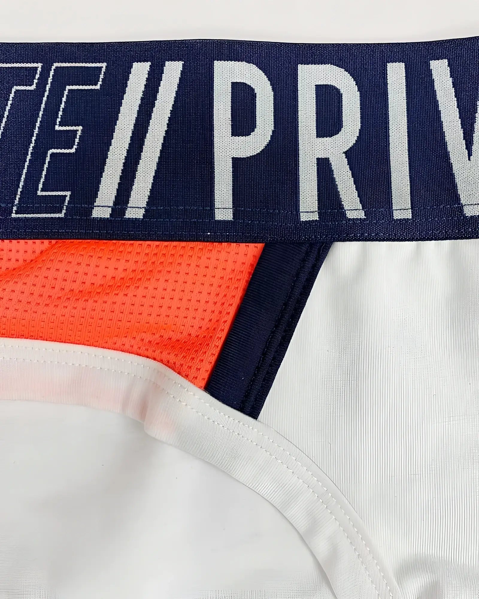 Private structure baut4388 athlete mini briefs in white with navy blue and bold orange mesh side panel for athletic use