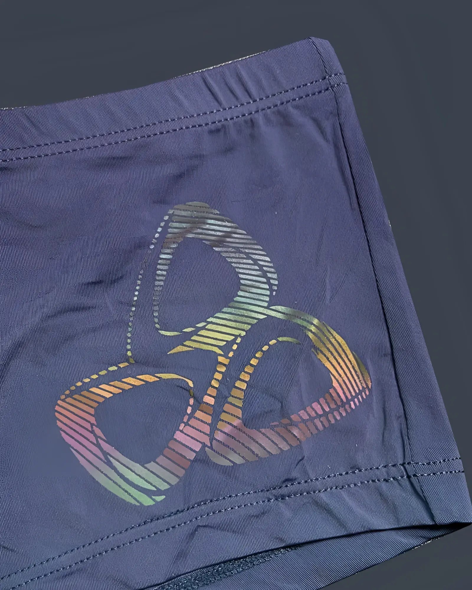 Dark blue Private Structure BRUT4390 bare hipster silk shorts with vibrant rainbow-striped abstract logo on fabric