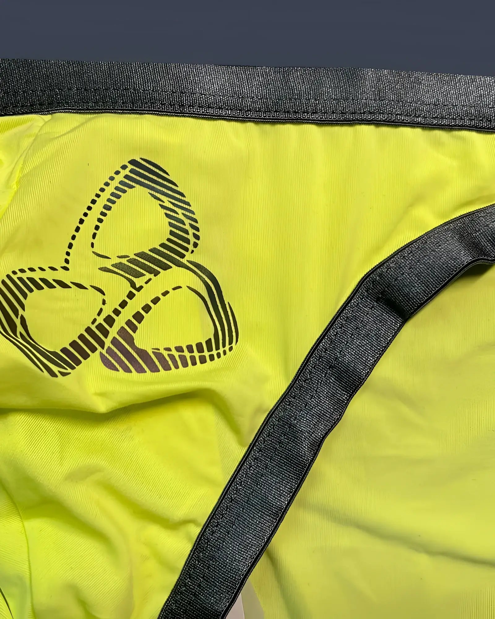 Bright yellow Private Structure BRUT4393 bare bikini briefs with black three-leaf logo and dark gray waistband
