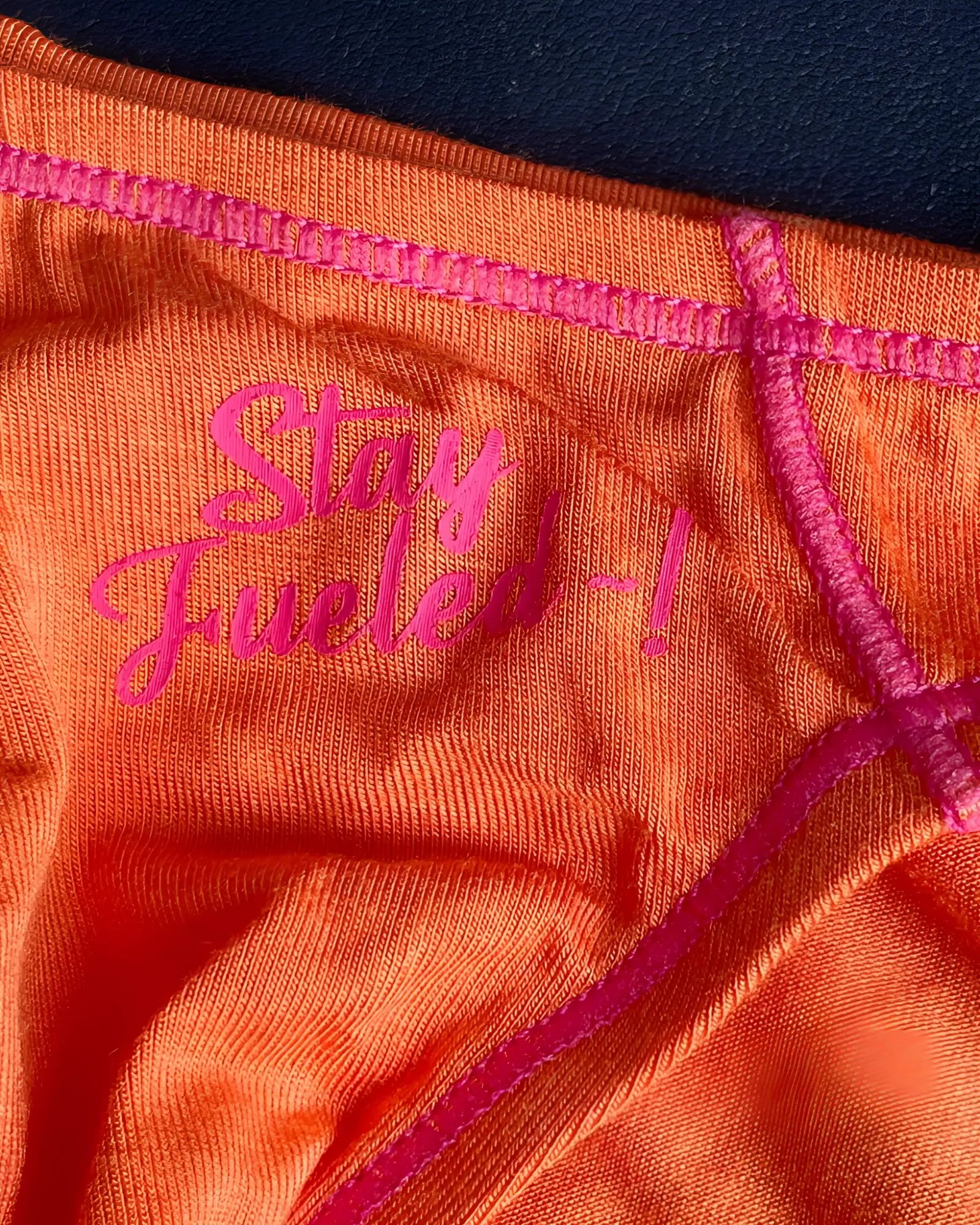Orange Private Structure EPUS4563 Prime Eutopia bikini brief with pink embroidered text and matching stitching in tangerine color