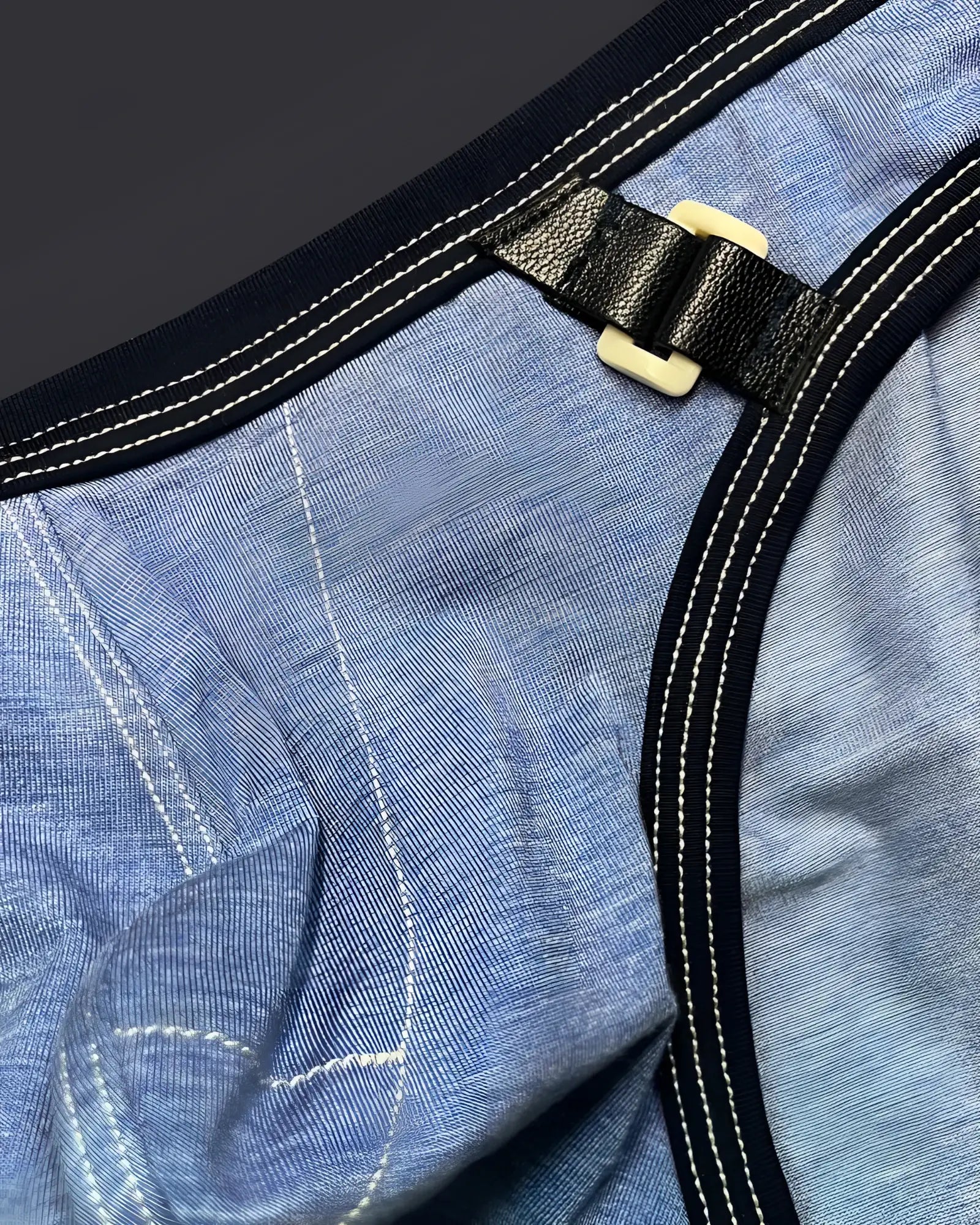Black leather strap with cream plastic buckle on blue denim private structure lcut4358 barn boy low rise mini brief