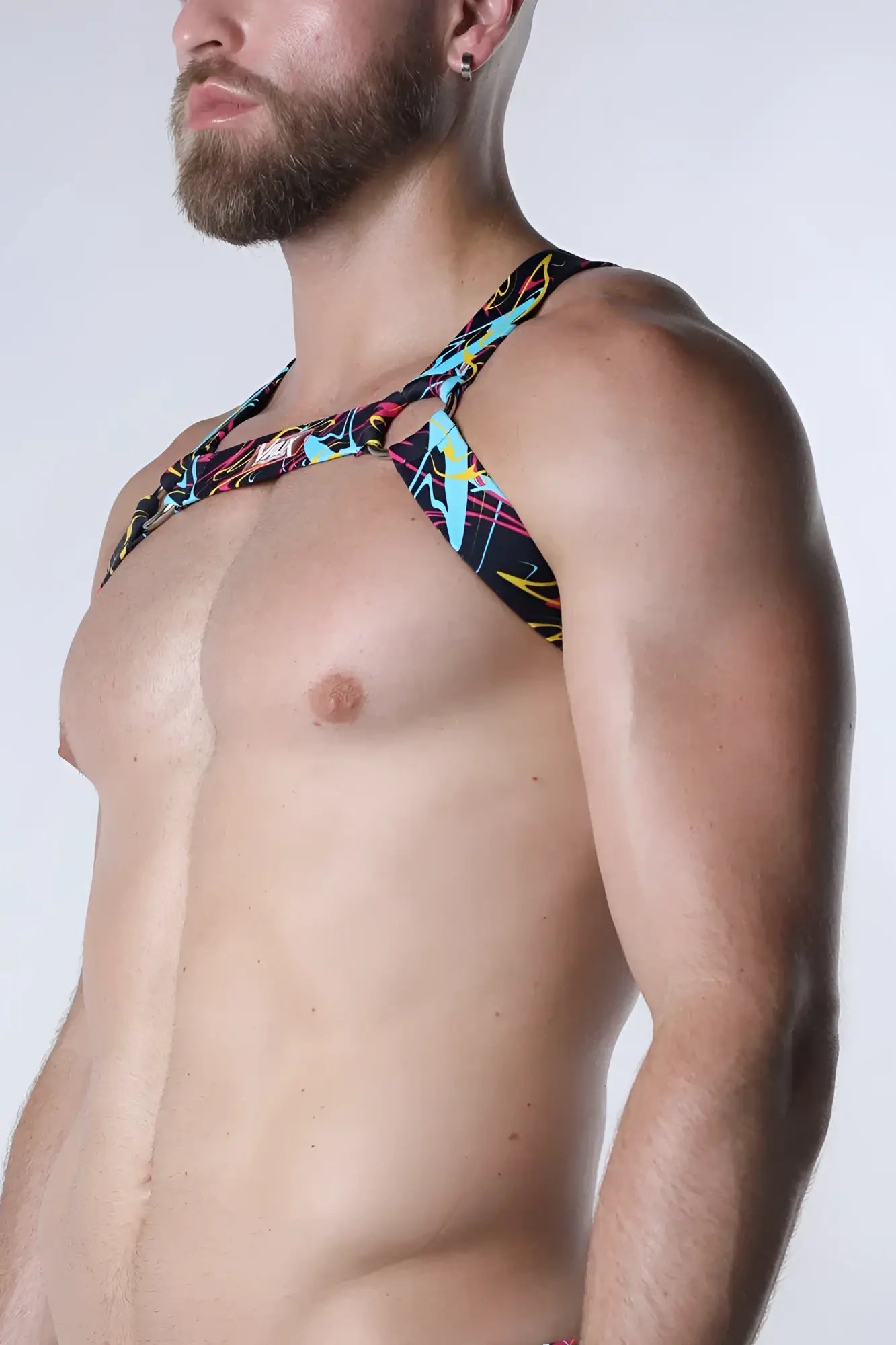 Pulse elastic harness black halter top with vibrant neon lightning bolt pattern and bold colorful abstract design