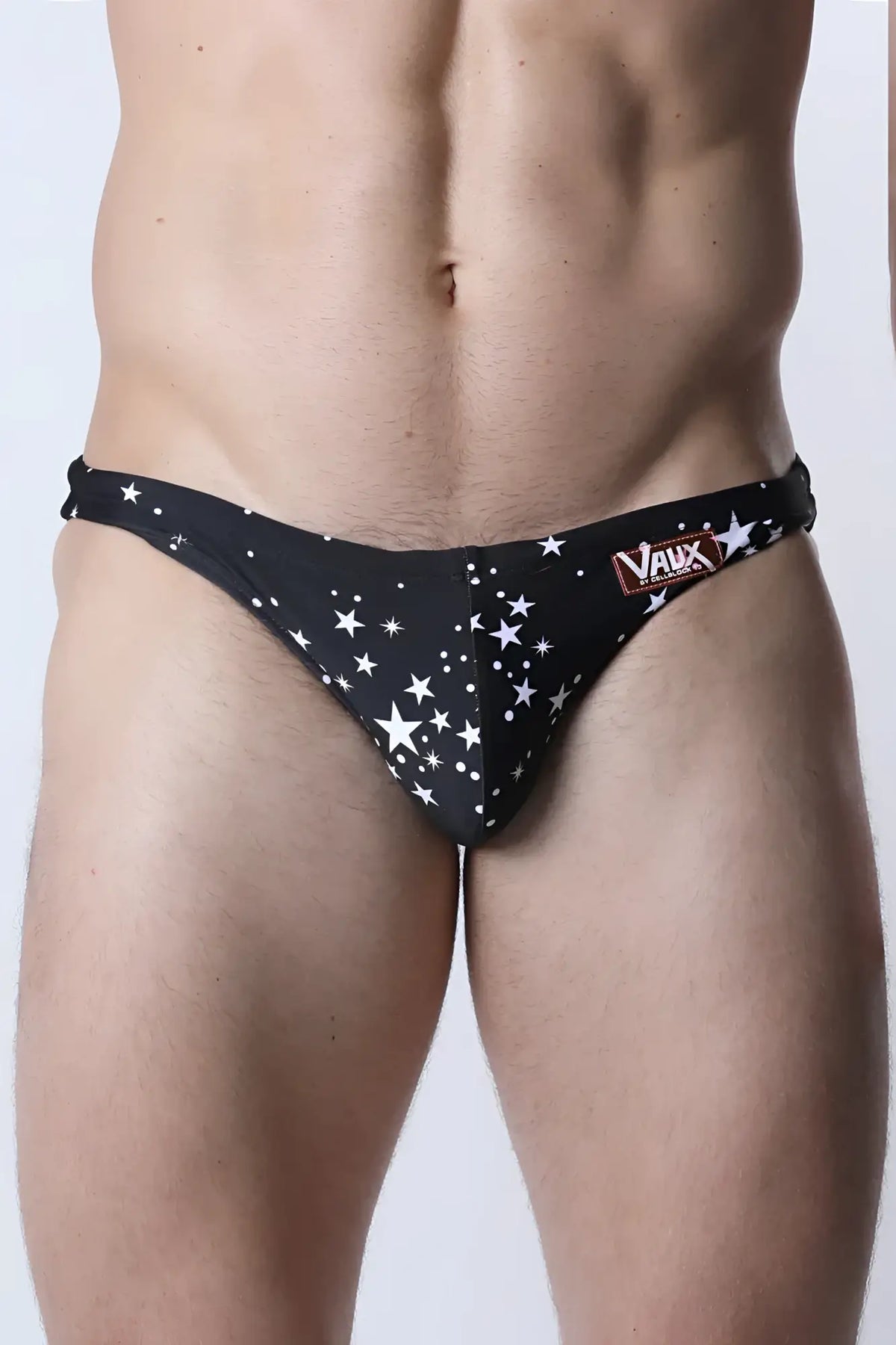 Black men’s swim trunks with star pattern and vaux brand label on waistband from pulse swim brief collection