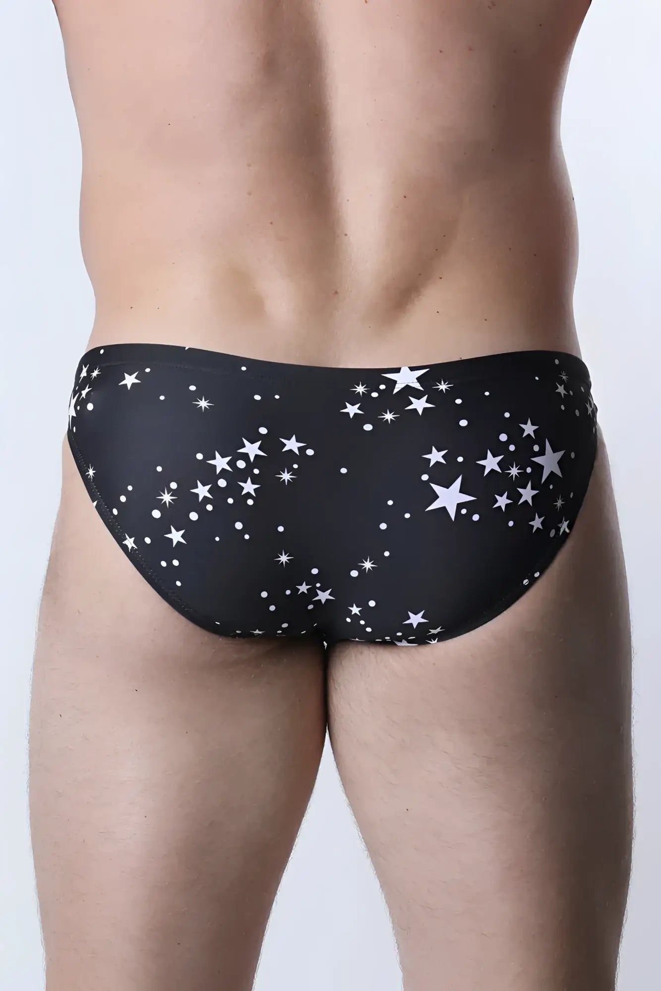 Pulse swim brief in black swim trunks with a white star and dot pattern for stylish swimwear use
