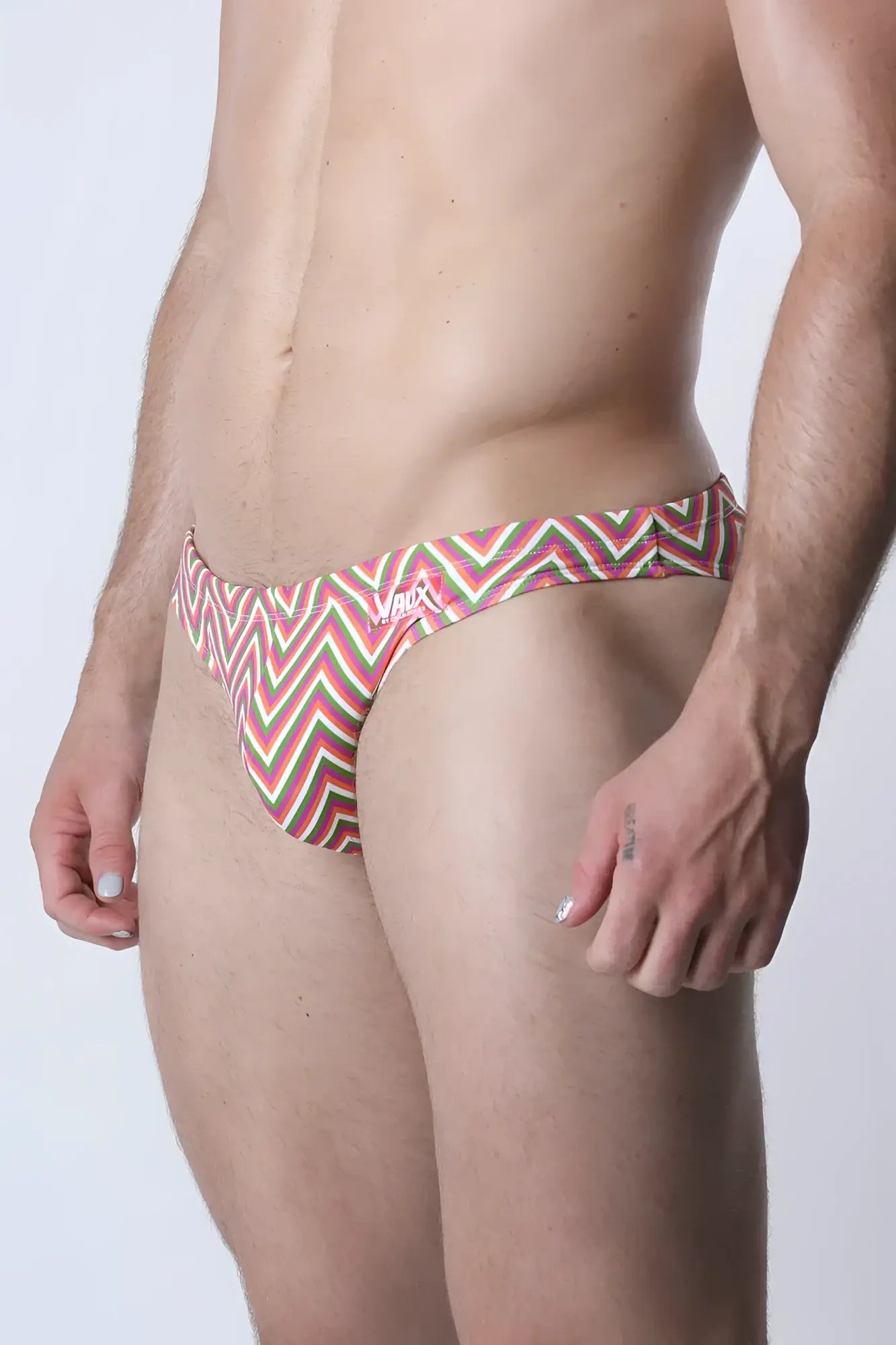 Vaux pulse swim brief men’s swim trunks with bold red green and white zigzag pattern for beach use