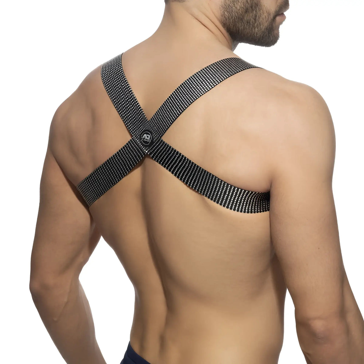 Black mesh crossback strap with skull logo at the center showing back side of pushpin spider harness