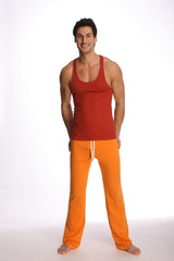 A man wearing a cinnabar racer-back yoga tank with a red front and orange pants with white drawstrings