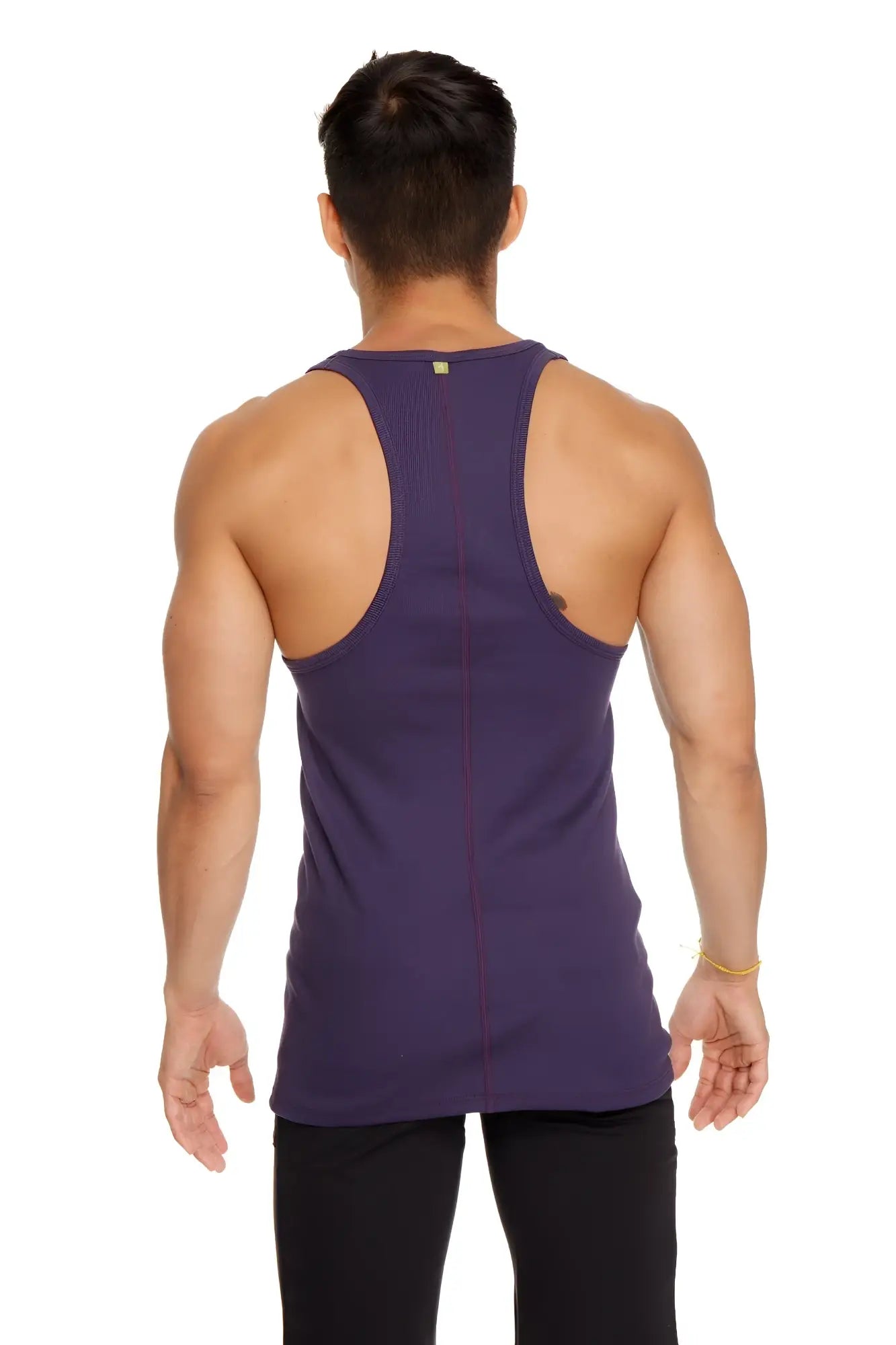 A deep purple form-fitting racer-back yoga tank with vertical seam detailing shown from the back side
