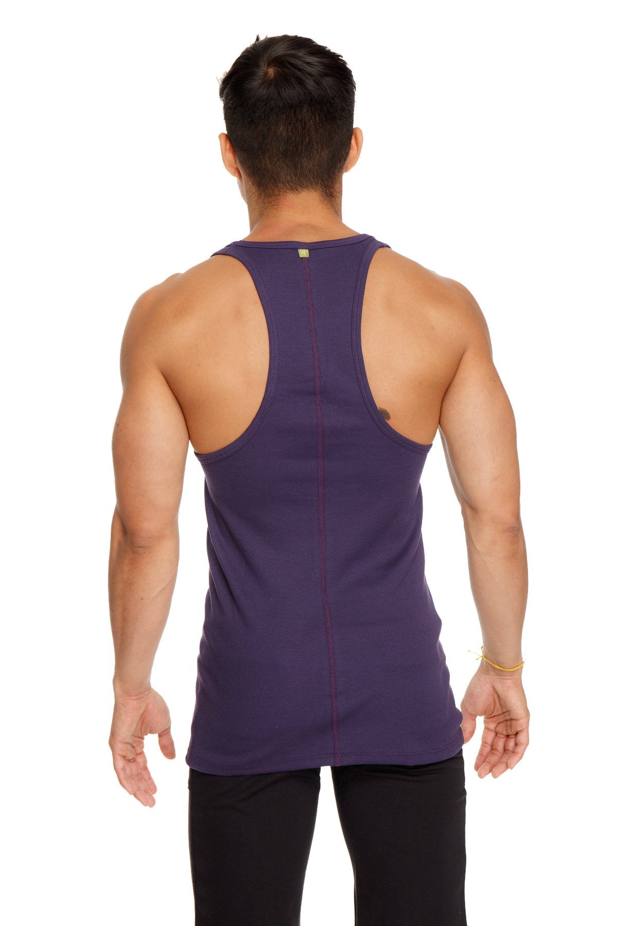 A deep purple form-fitting racer-back yoga tank with vertical seam detailing shown from the back side