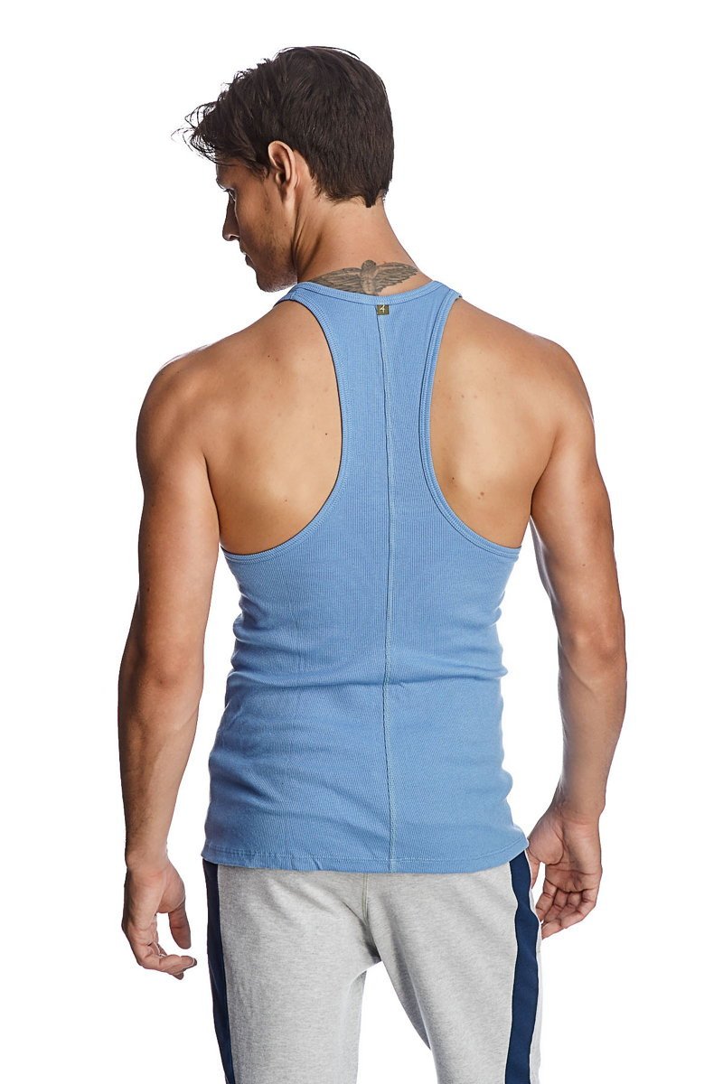 Light blue ribbed cotton racer-back yoga tank top with small green logo at neckline