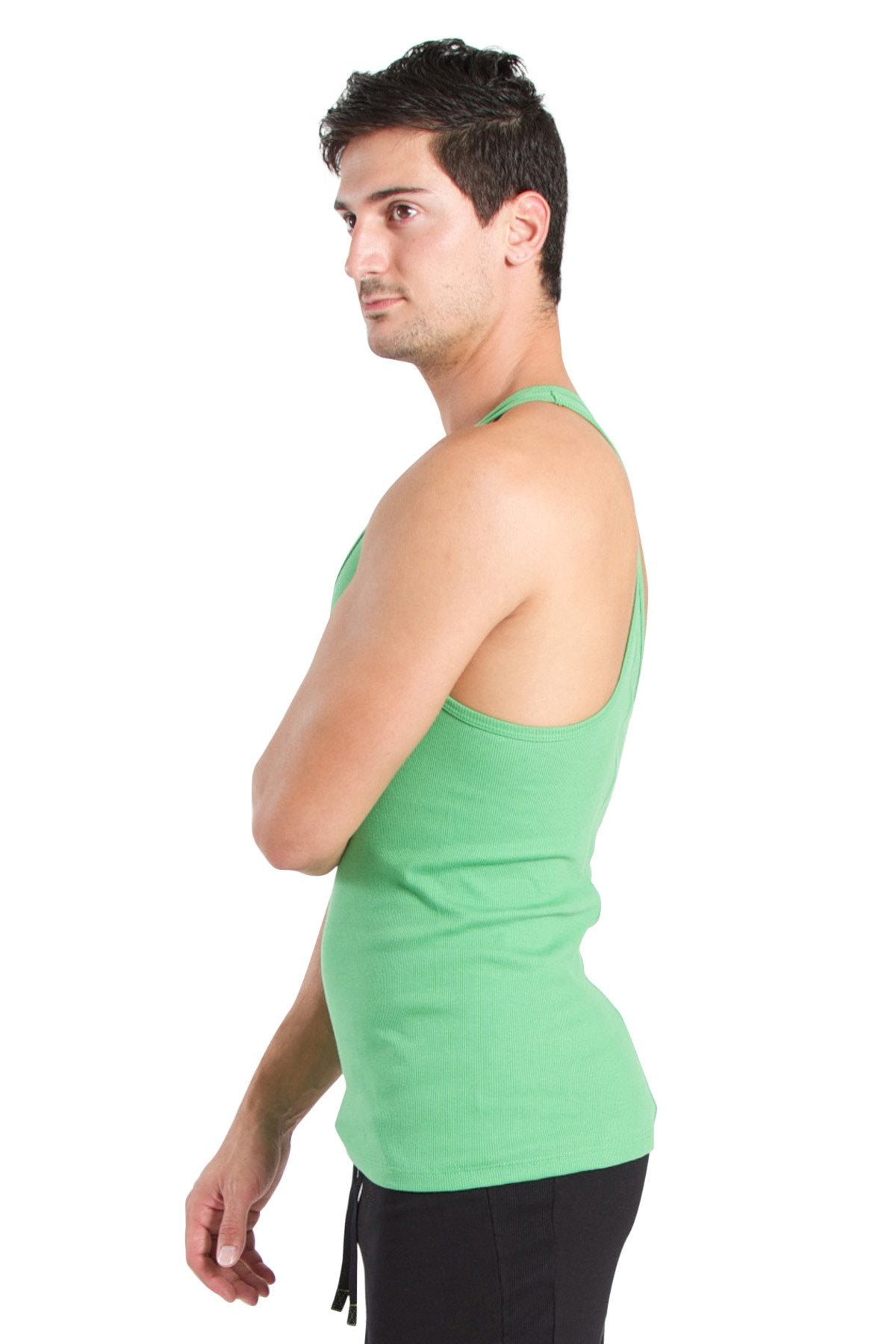 A man wearing a bamboo green racerback yoga tank top with a fitted cut and thin straps in solid green