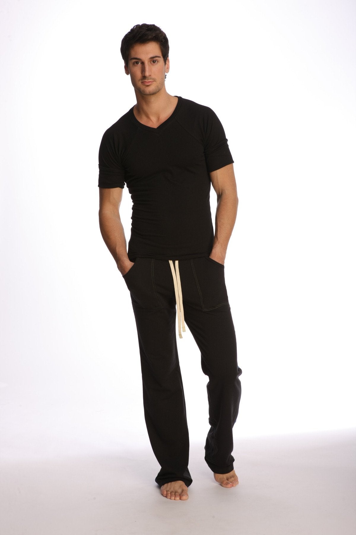 Black cotton joggers with cream-colored drawstrings paired with raglan virtual crew neck in black shown from the front