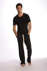 Black cotton joggers with cream-colored drawstrings paired with raglan virtual crew neck in black shown from the front