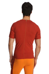 Back view of a fitted short-sleeved orange cinnabar raglan virtual crew neck athletic shirt with central zipper and seam detailing