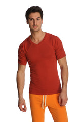 A man wearing a vibrant red raglan virtual crew neck t-shirt with subtle seam detailing and short sleeves
