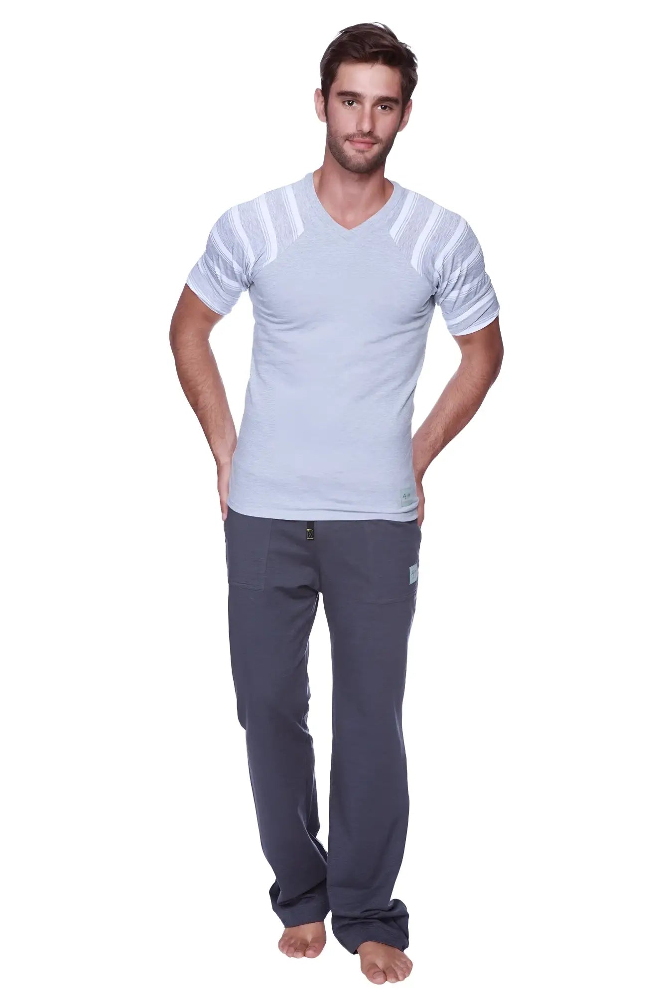 A man wearing a raglan virtual crew neck grey with grey and white stripe light gray v-neck t-shirt with stripes and dark gray pants