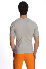 Back view of a heather grey raglan virtual crew neck short-sleeved athletic shirt with a central seam down the back