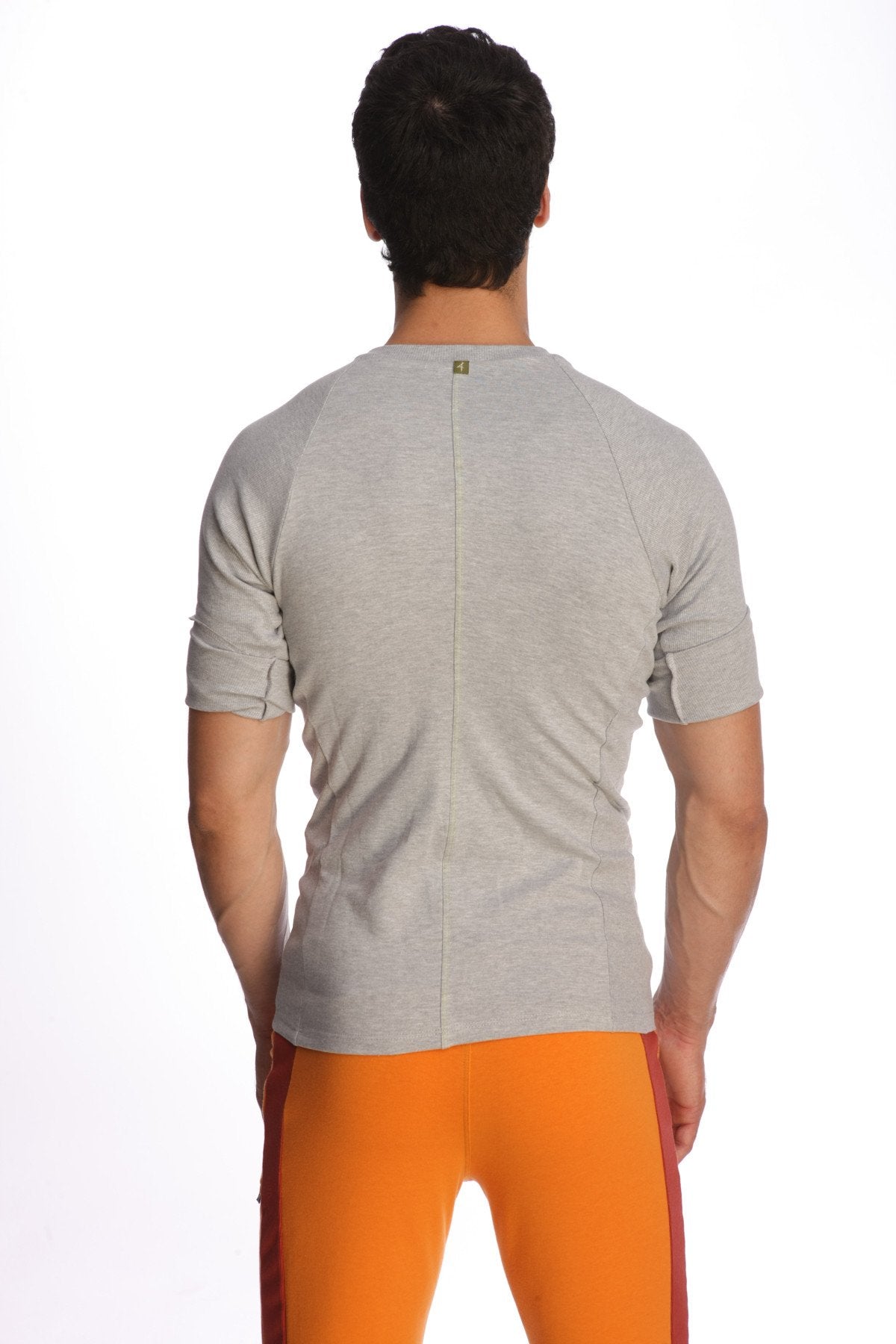 Back view of a heather grey raglan virtual crew neck short-sleeved athletic shirt with a central seam down the back