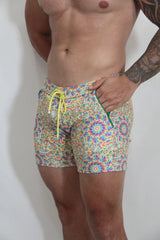 Rainbow kaleidoscope linen texture shorts with vibrant multicolored geometric pattern neon yellow drawstring and green zipper accents
