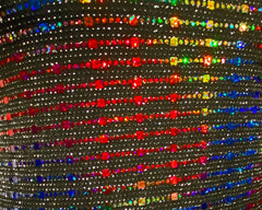 Rainbow sequin tank featuring shimmering black fabric with vibrant rainbow-colored rhinestones in diagonal rows