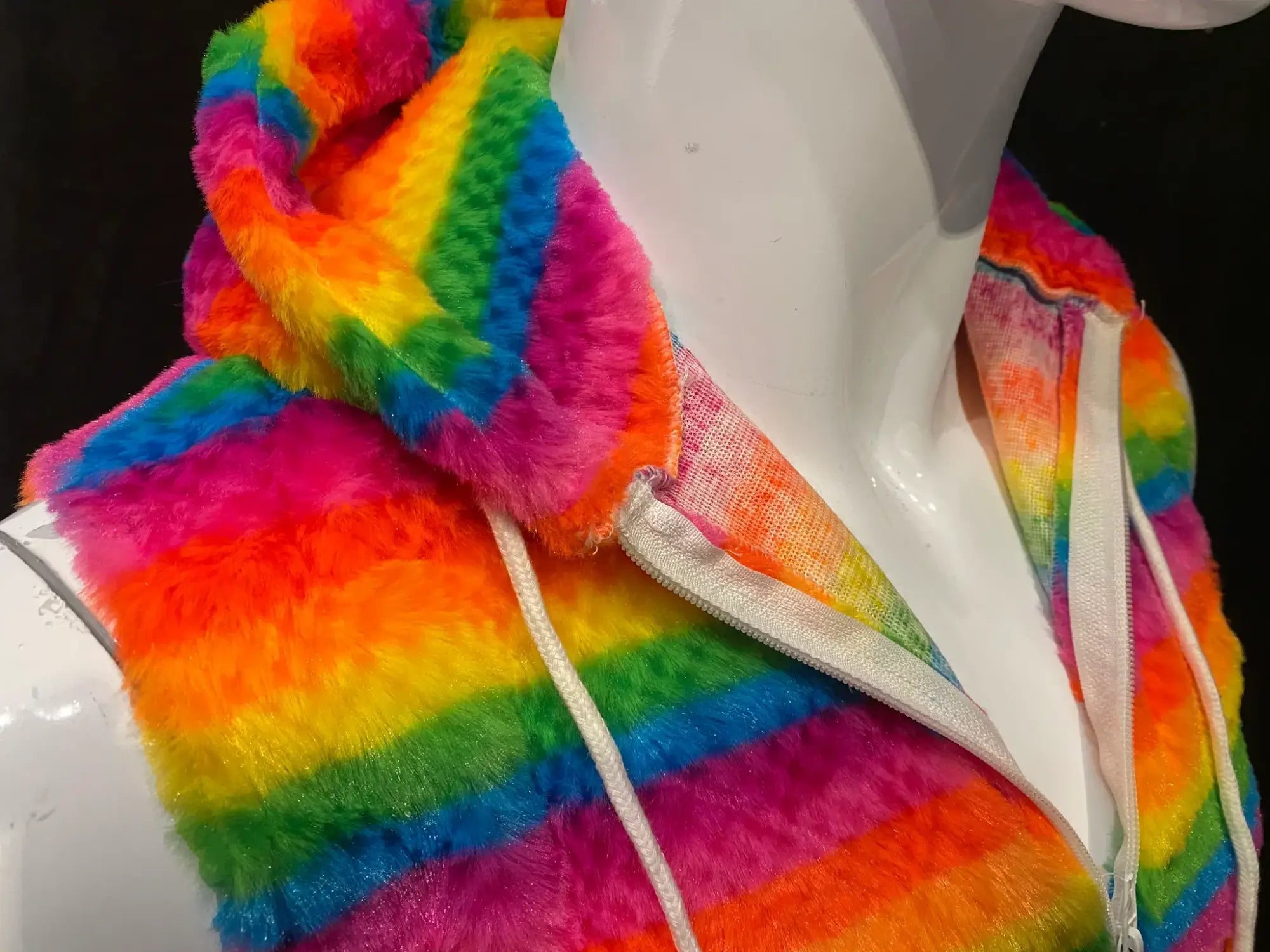 Rainbow stripe faux fur hoodie with vibrant rainbow stripes fuzzy plush material and white drawstrings