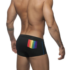 Black swim trunks with a vibrant rainbow-colored pocket and blue side trim perfect for beachwear