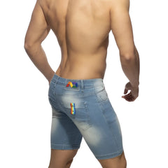 Back view of light-wash denim rainbow tape jean short with rainbow patches on waistband and right pocket