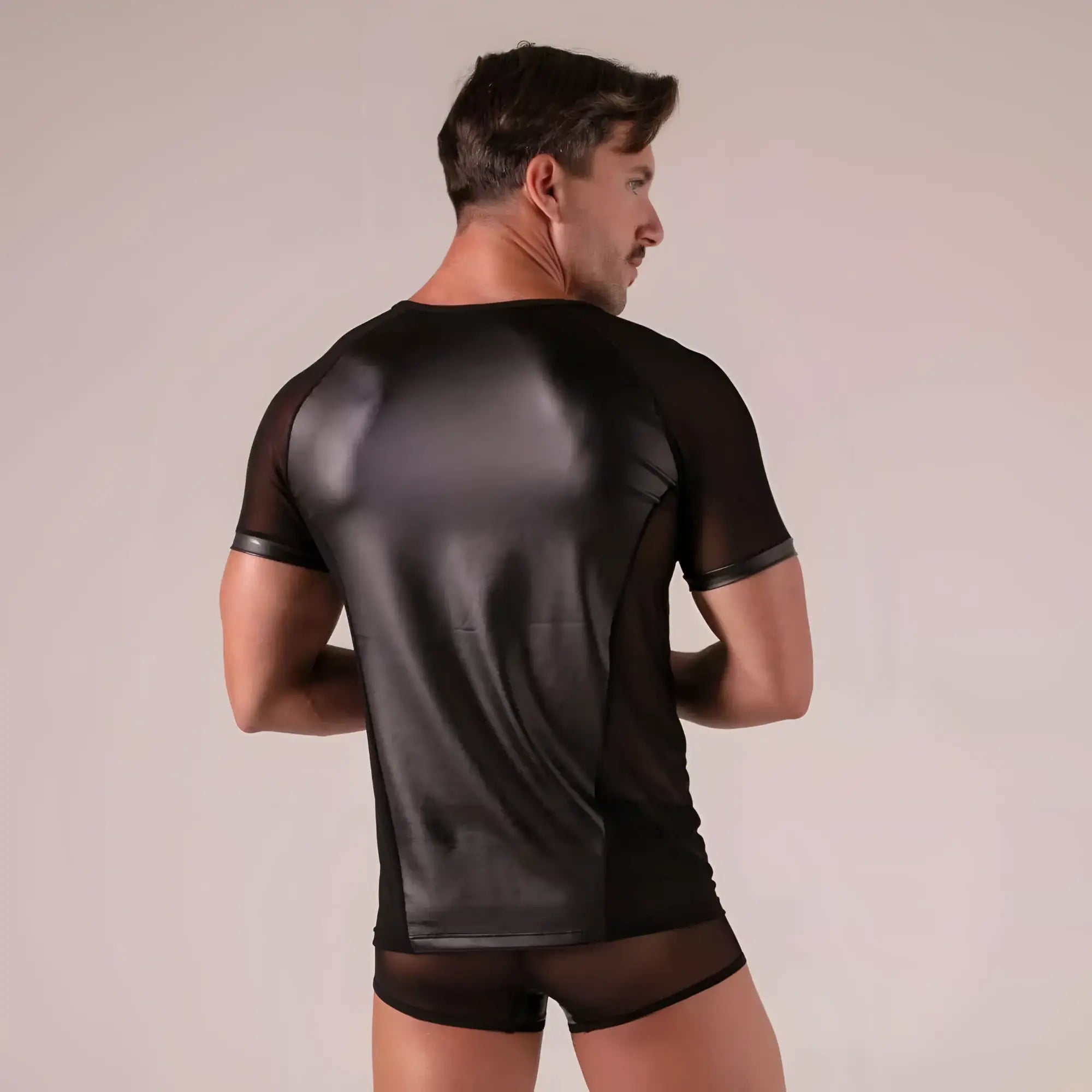 Back view of rebel t-shirt black short-sleeved with a glossy faux leather panel and sheer mesh sides and sleeves
