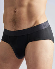 Black men’s reign brief with dark gray elastic waistband featuring subtle team logo in soft fabric for everyday comfort