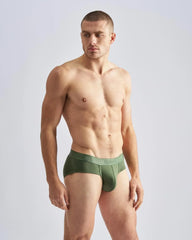 Olive green men’s cotton briefs with matching elastic waistband featuring team brand name in white lettering