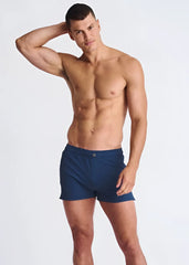 Navy blue riviera seersucker swim shorts with mesh lining and single button waistband closure for athletic use