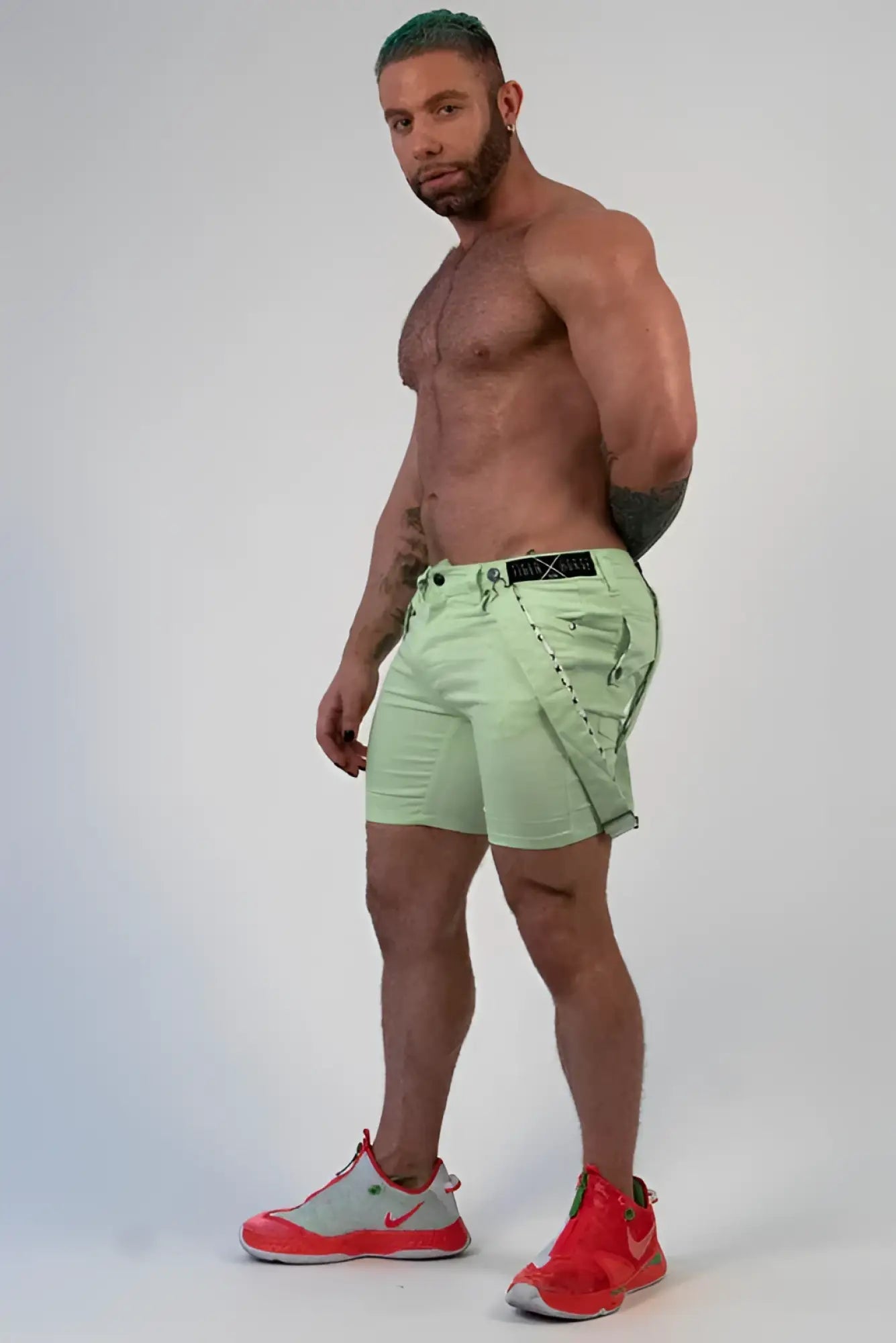 Light green Romey shorts cargo style with black belt and stitched detailing for casual wear