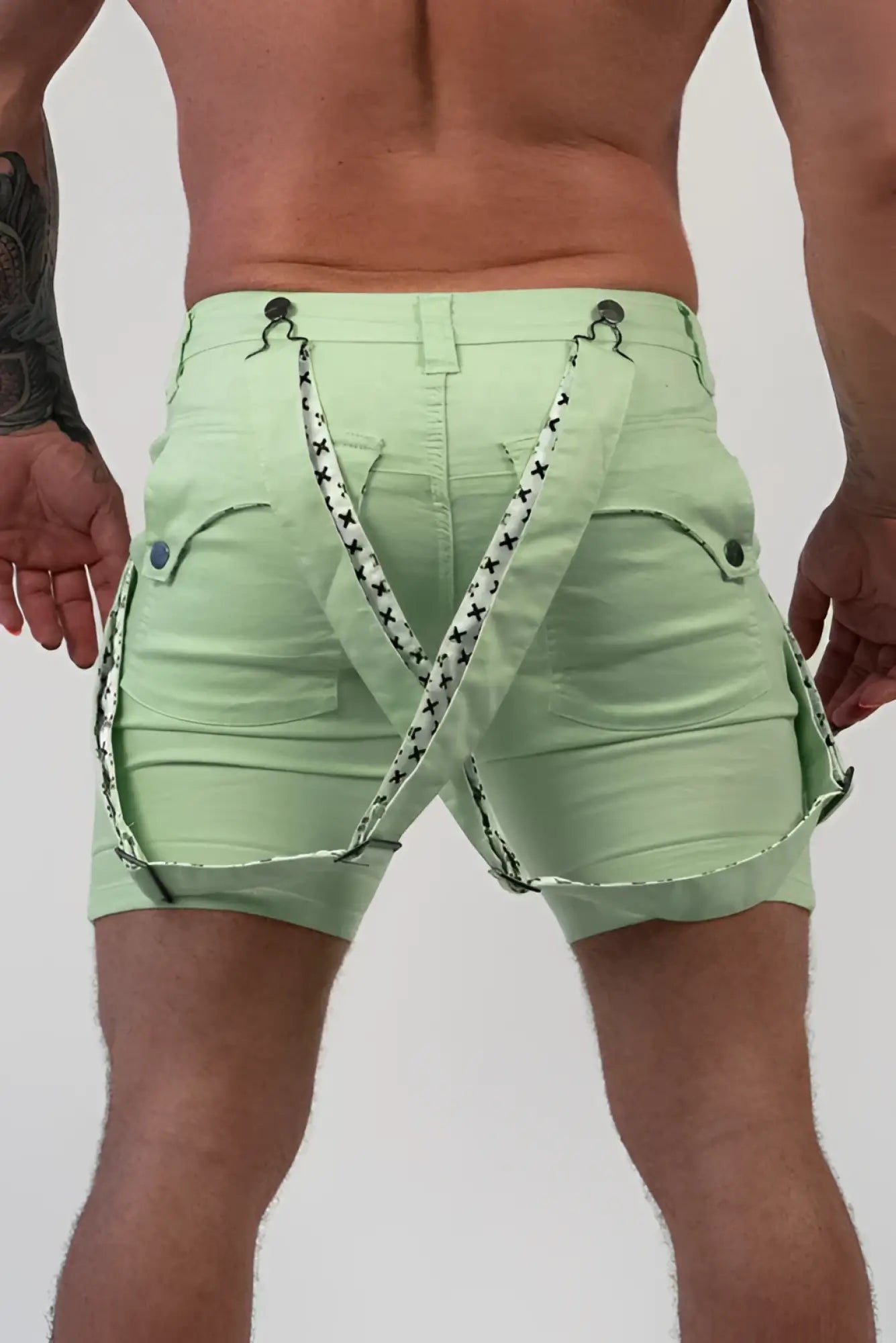Light green denim romey shorts with black and white star patterned suspenders for casual wear