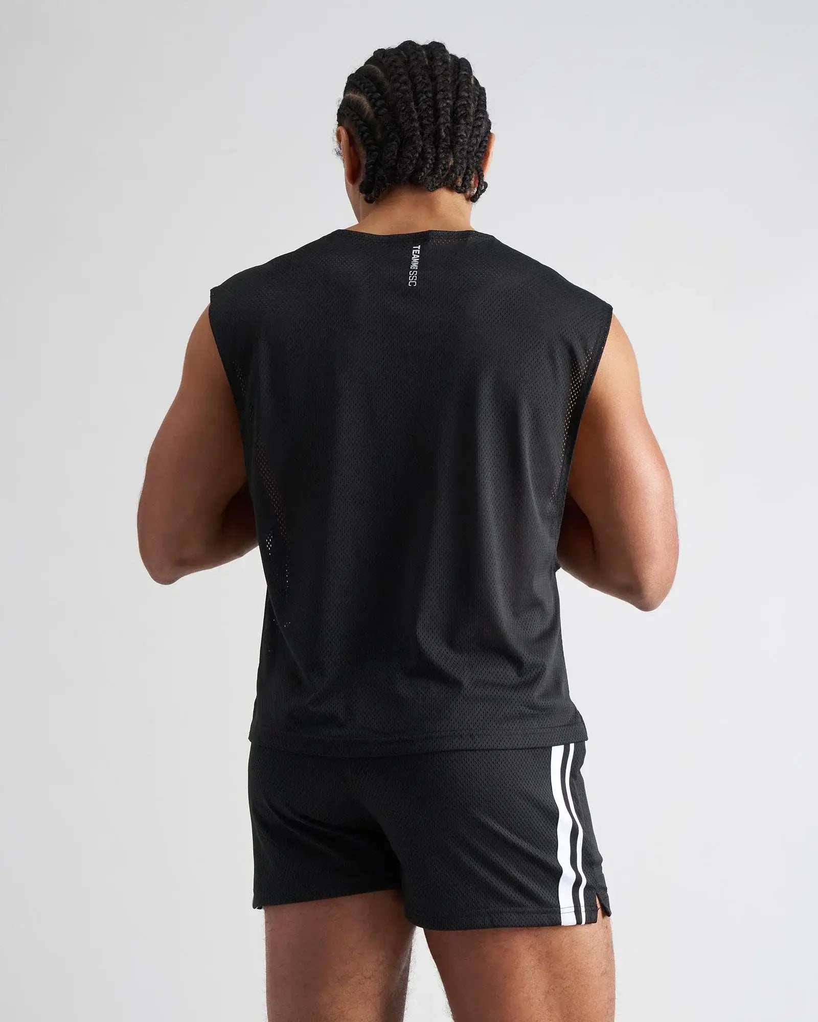 Black mesh sleeveless athletic top with subtle vertical logo on back in s.s.c. mesh muscle tank design