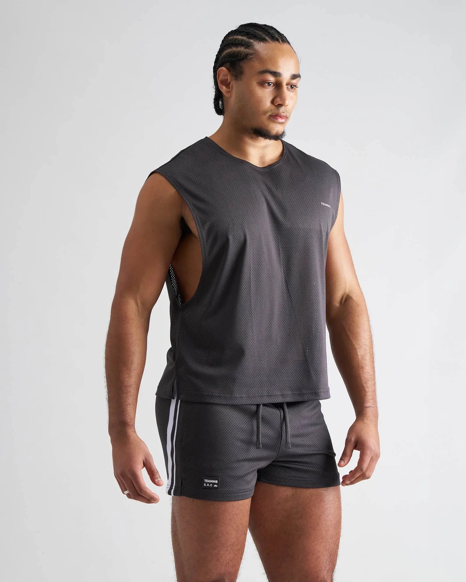 Dark gray sleeveless s.s.c. mesh muscle tank with textured mesh fabric and cut-out side panels for athletic wear