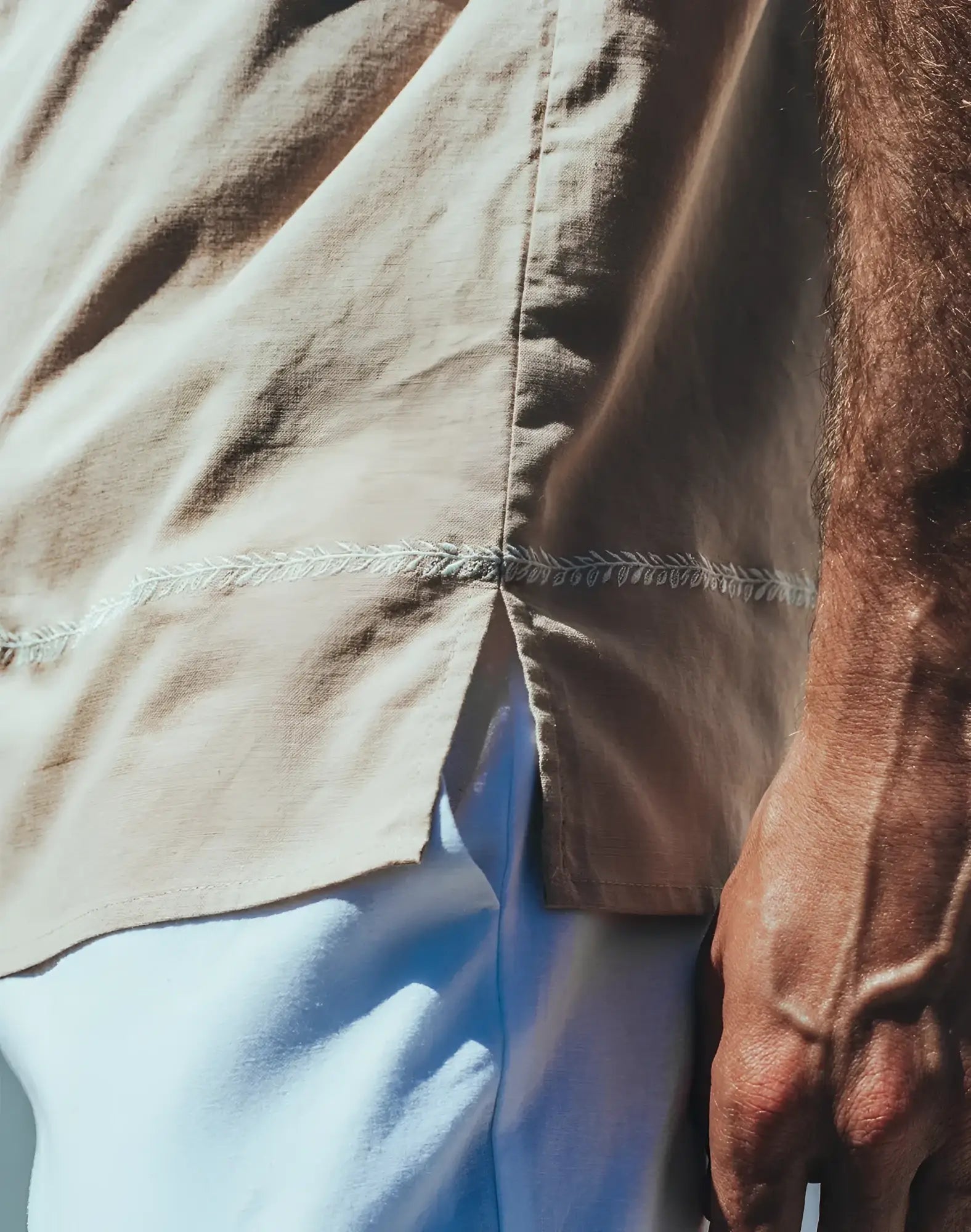 Beige Santorini linen shirt with delicate white leaf embroidery along the seam made from breathable linen fabric