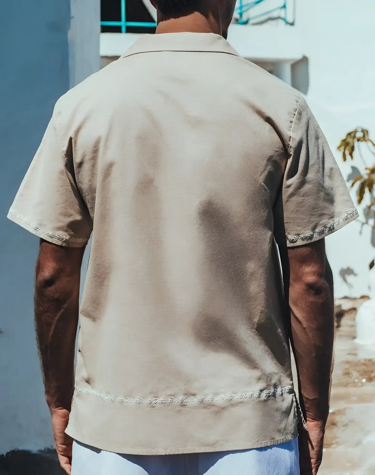Beige santorini linen shirt with short sleeves and subtle embroidered trim on collar sleeve hems and bottom hem