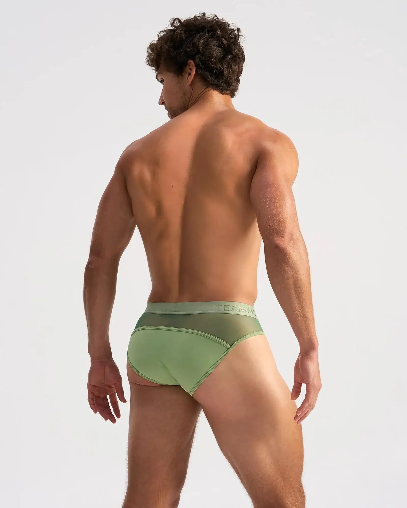 Light green score sheer brief with form-fitting fit mesh back panel and elastic waistband with faint branding visible from back