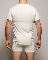 A sleek form-fitting seamless active white t-shirt made of cotton with short sleeves and rounded neckline